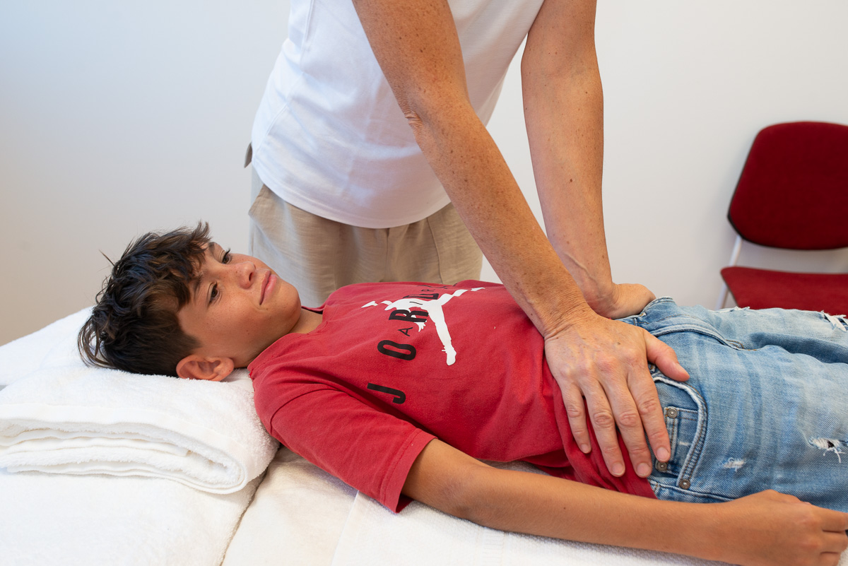 Therapist performing massage on a child