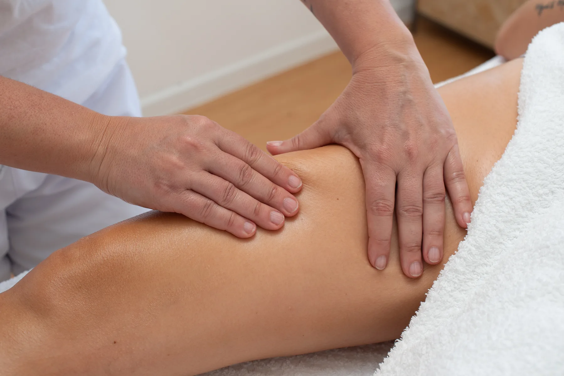 chiropractic performing leg massage on patient's leg
