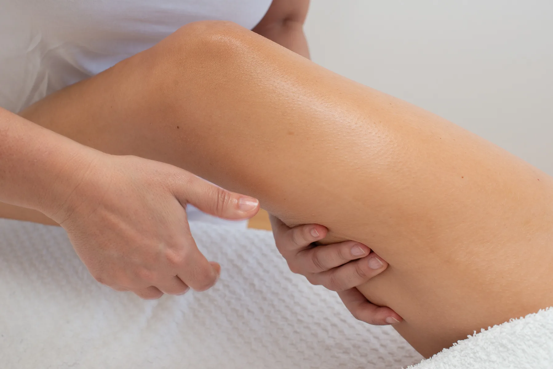 chiropractic performing leg massage on patient's leg