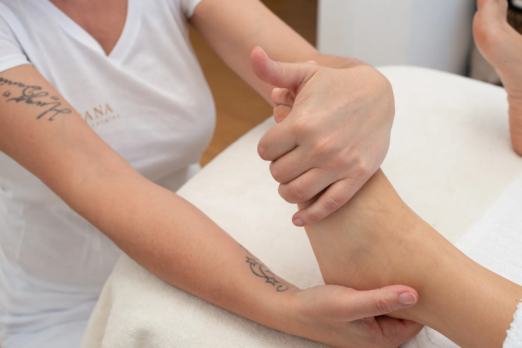 Chiropractor performing foot treatment to patient